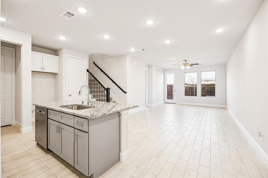 817 Heart Reef Road Plano, TX 75075 - Photo 7 of 21 a kitchen with a sink and chandelier