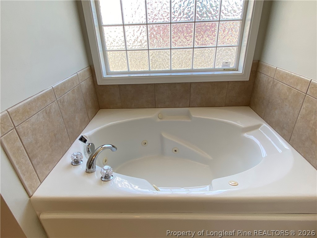 58 Polk Street Spring Lake, NC 28390 - Photo 16 of 26 a bath tub sitting in a bathroom next to a window