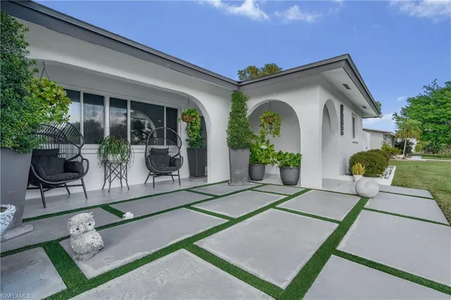 a front view of house with a garden