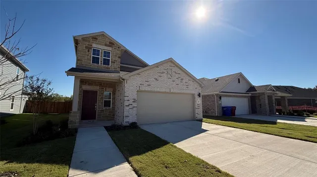 a front view of a house with yard