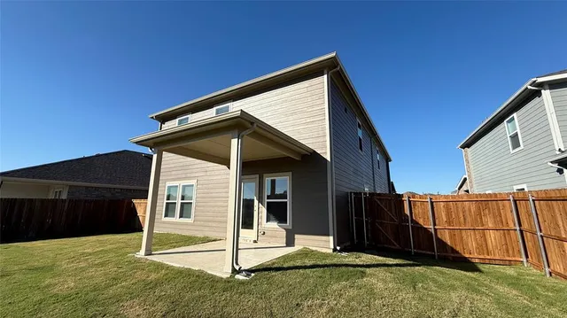 a backyard of a house with wooden fence