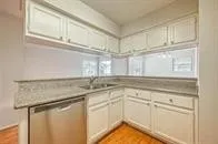 a kitchen with appliances cabinets and a counter top space