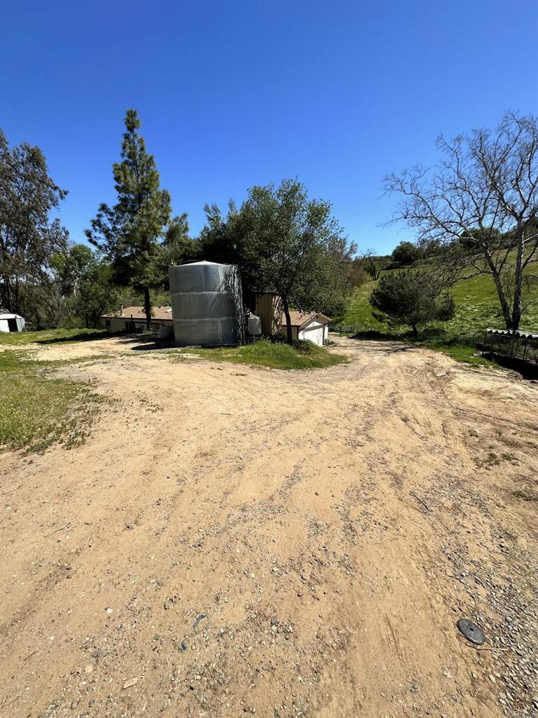 18597 Bee Canyon Road Dulzura, CA 91917 - Photo 1 of 1 a wooden fence with some trees in the background