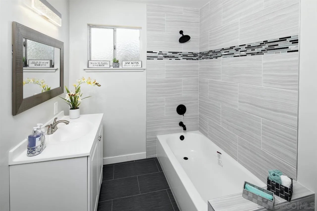 1050 Tiger Tail Road Vista, CA 92084 - Photo 11 of 28 a bathroom with a tub a sink and mirror