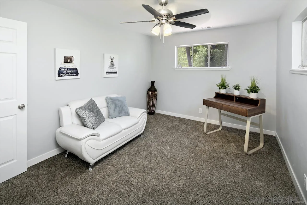 1050 Tiger Tail Road Vista, CA 92084 - Photo 12 of 28 a living room with furniture and a painting on the wall