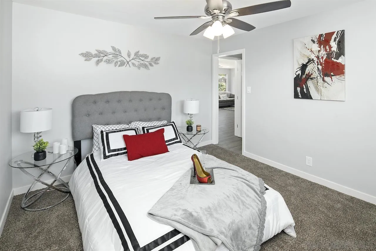 1050 Tiger Tail Road Vista, CA 92084 - Photo 13 of 28 a bedroom with a bed and a chandelier