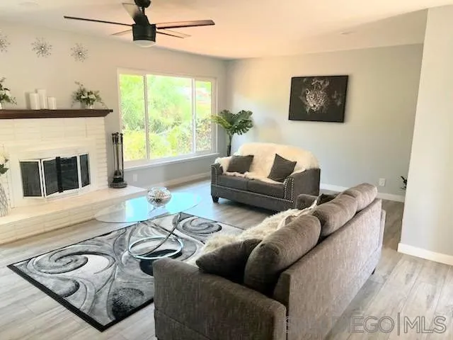 1050 Tiger Tail Road Vista, CA 92084 - Photo 20 of 28 a living room with furniture and a fireplace