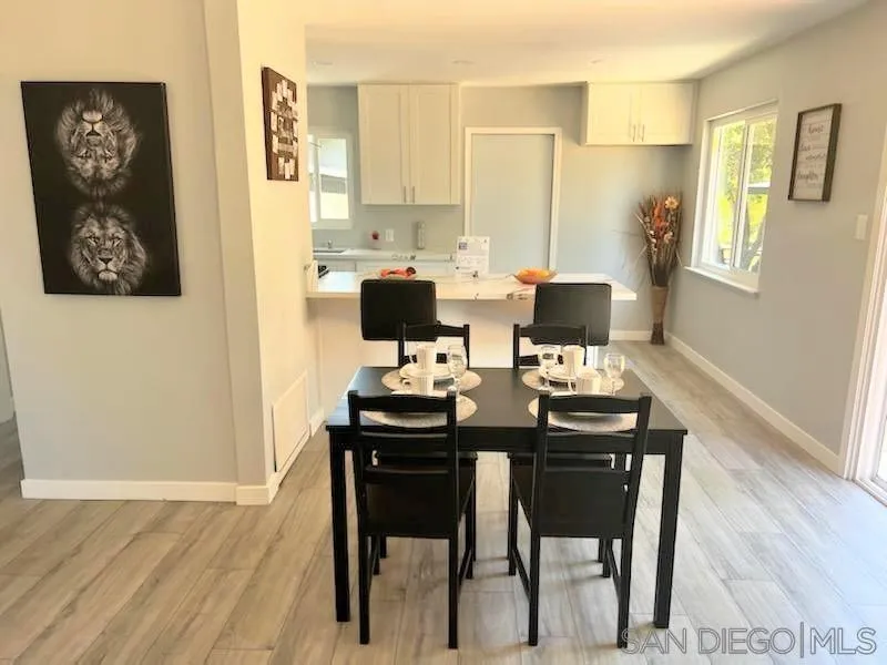 1050 Tiger Tail Road Vista, CA 92084 - Photo 22 of 28 a view of a dining room with furniture and wooden floor