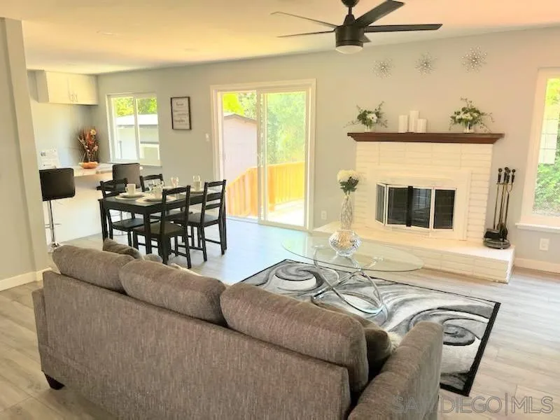 1050 Tiger Tail Road Vista, CA 92084 - Photo 24 of 28 a living room with furniture and a fireplace