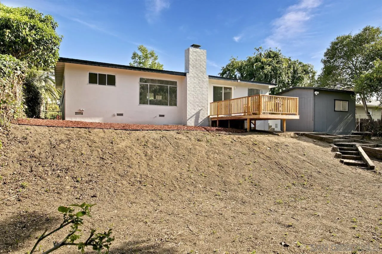 1050 Tiger Tail Road Vista, CA 92084 - Photo 25 of 28 a view of a house with a patio and a yard