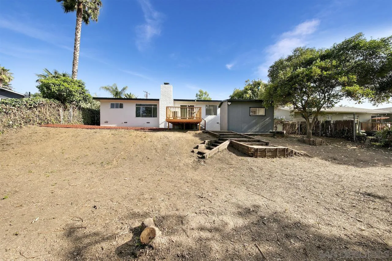 1050 Tiger Tail Road Vista, CA 92084 - Photo 27 of 28 a view of a house with backyard and a tree