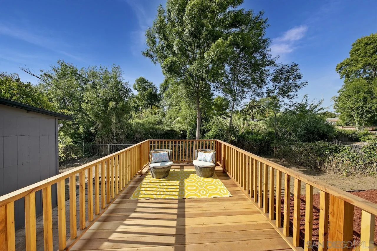 1050 Tiger Tail Road Vista, CA 92084 - Photo 3 of 28 a view of a balcony with wooden floor and fence