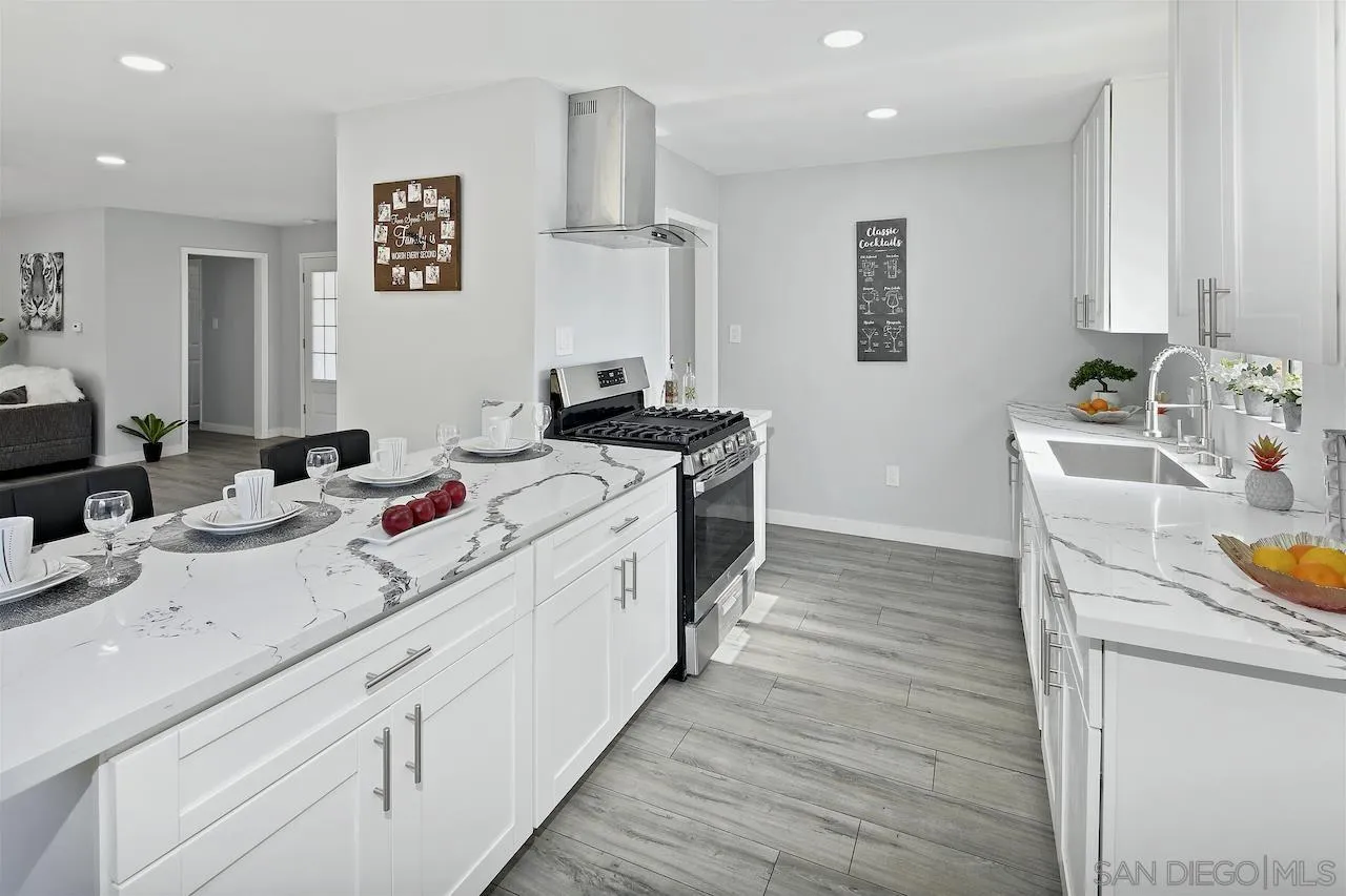 1050 Tiger Tail Road Vista, CA 92084 - Photo 6 of 28 a kitchen with a sink stove and wooden floor