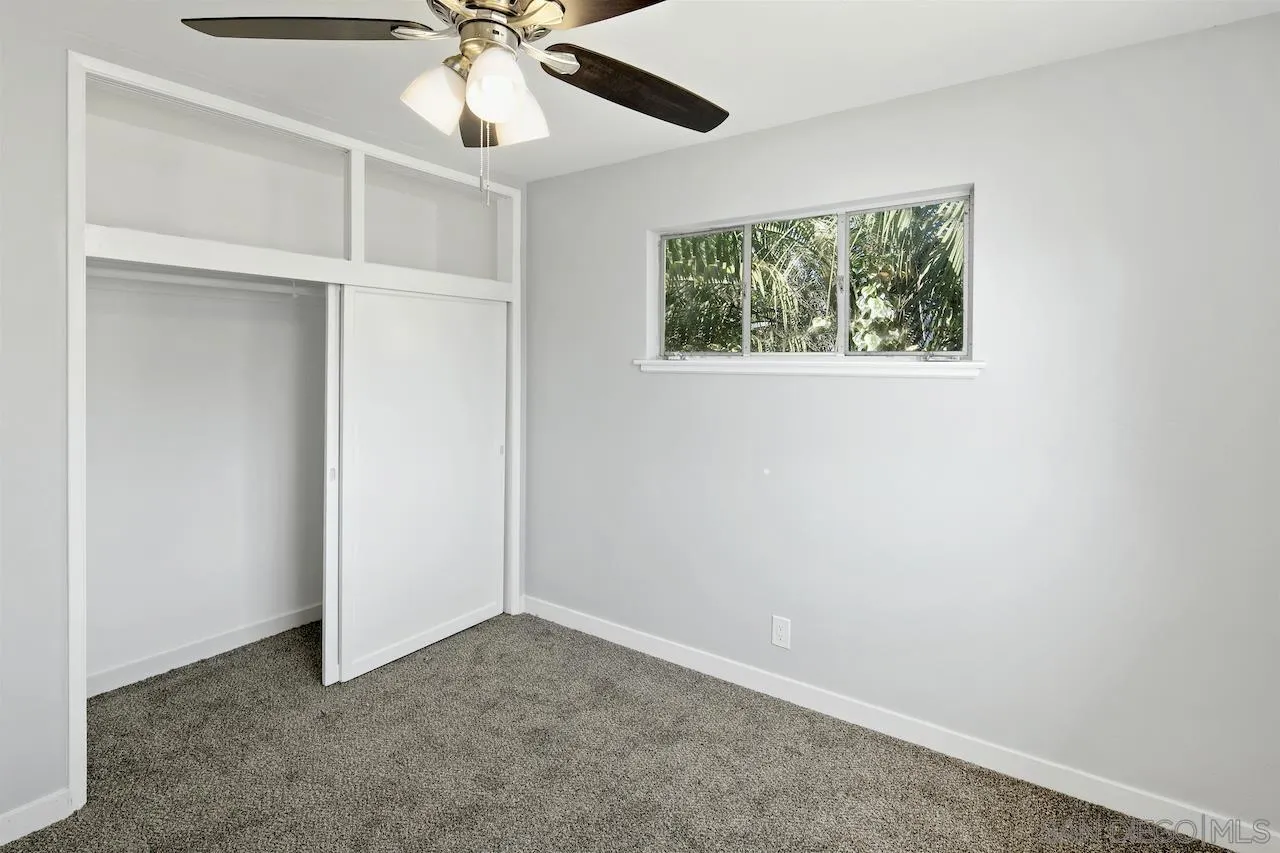 1050 Tiger Tail Road Vista, CA 92084 - Photo 9 of 28 an empty room with a window and a fan