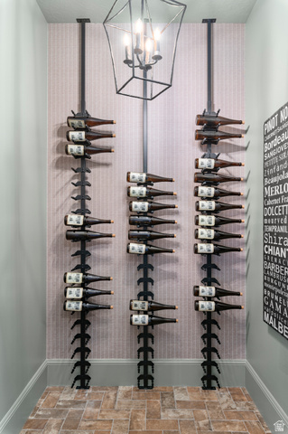 2192 East Outlaw Road Kamas, UT 84036 - Photo 16 of 80 Specialized wine storage featuring three vertical racks, a geometric pendant light fixture, and patterned wall covering