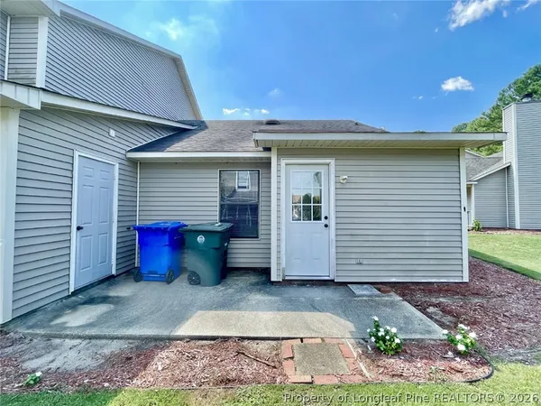 a view of a small house with backyard