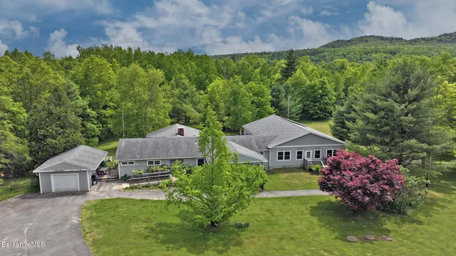 an aerial view of a house with garden space and a street view