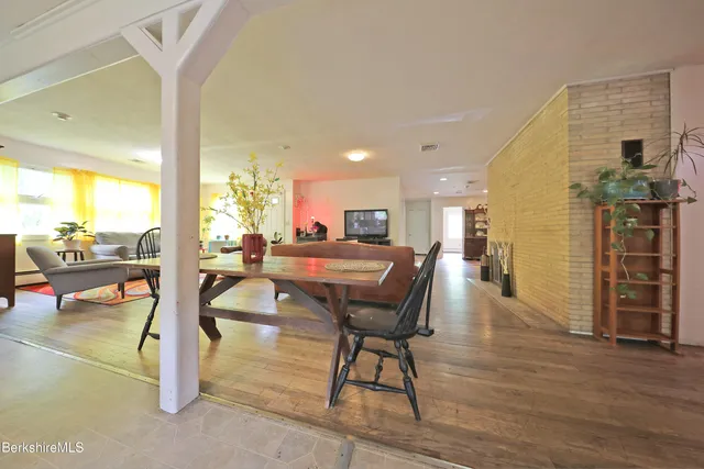 a view of a livingroom with furniture window and wooden floor