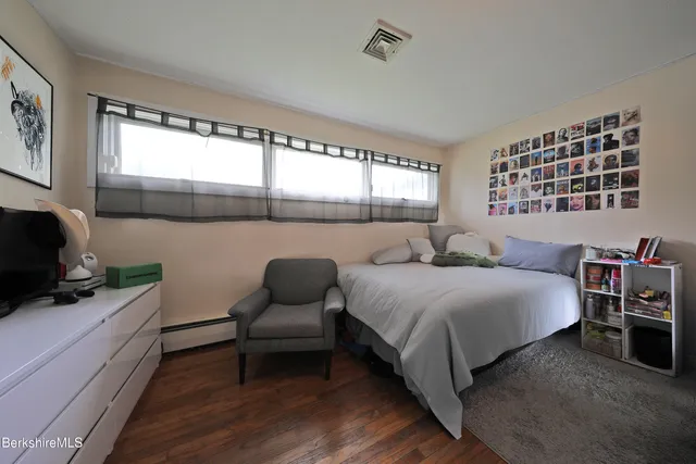 a bedroom with a bed and a chair