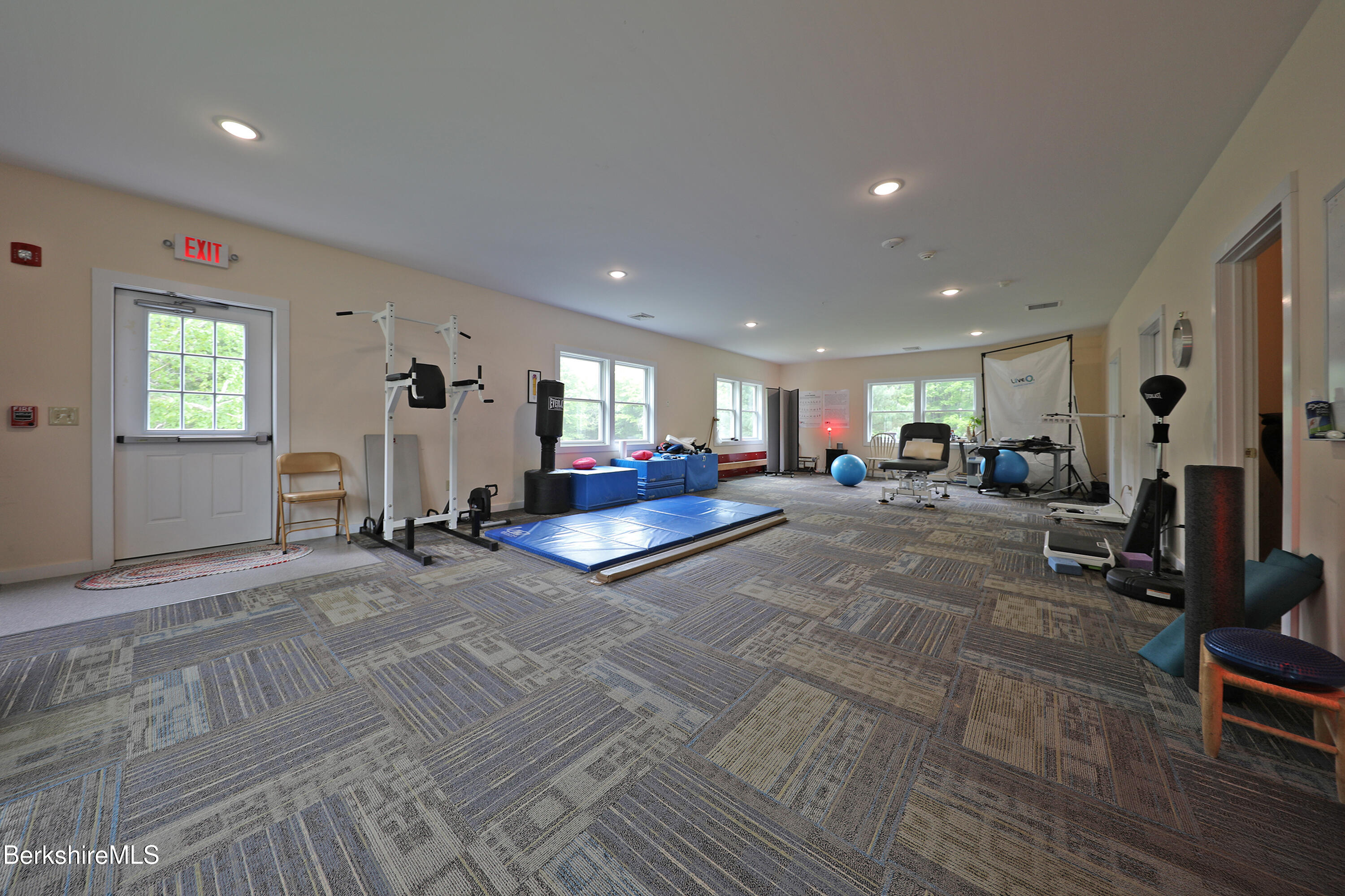 458 Monterey Road Great Barrington, MA 01230 - Photo 28 of 36 a living room with furniture a window and gym equipment
