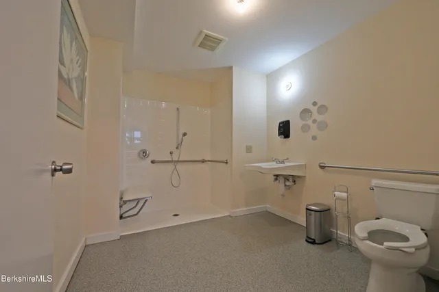 a bathroom with a toilet sink and shower