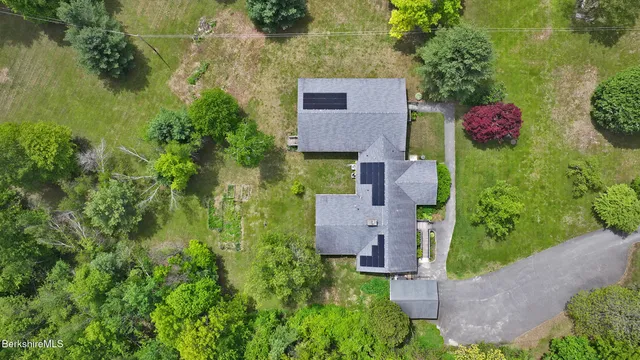 an aerial view of a house with a yard