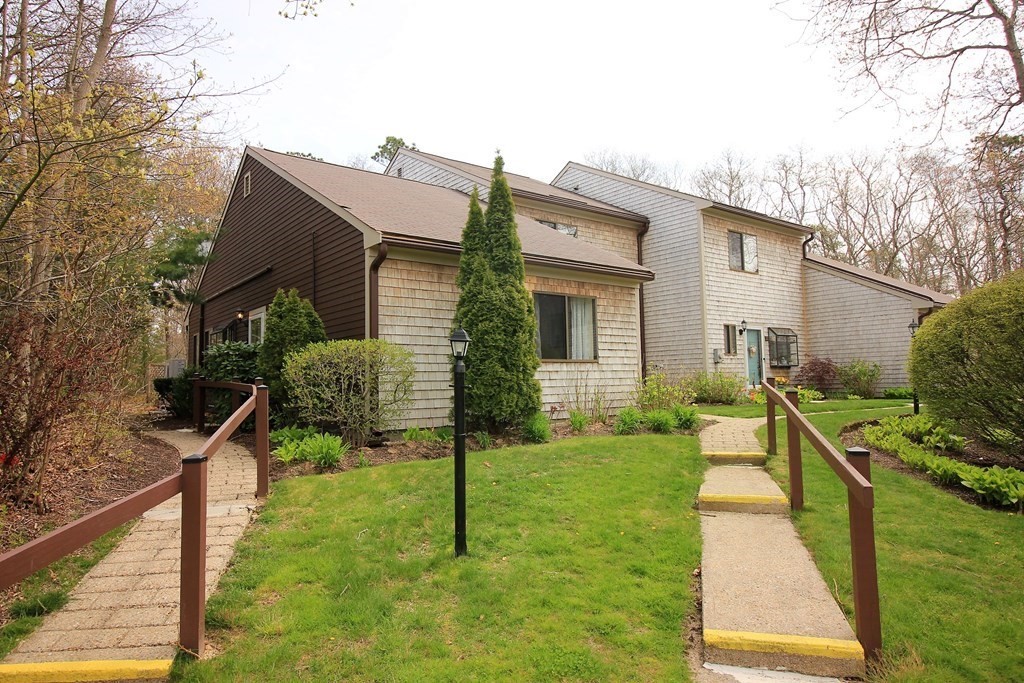 30 Round House Road, Unit 30 Bourne, MA 02532 - Photo 1 of 19 a house view with a seating space and garden