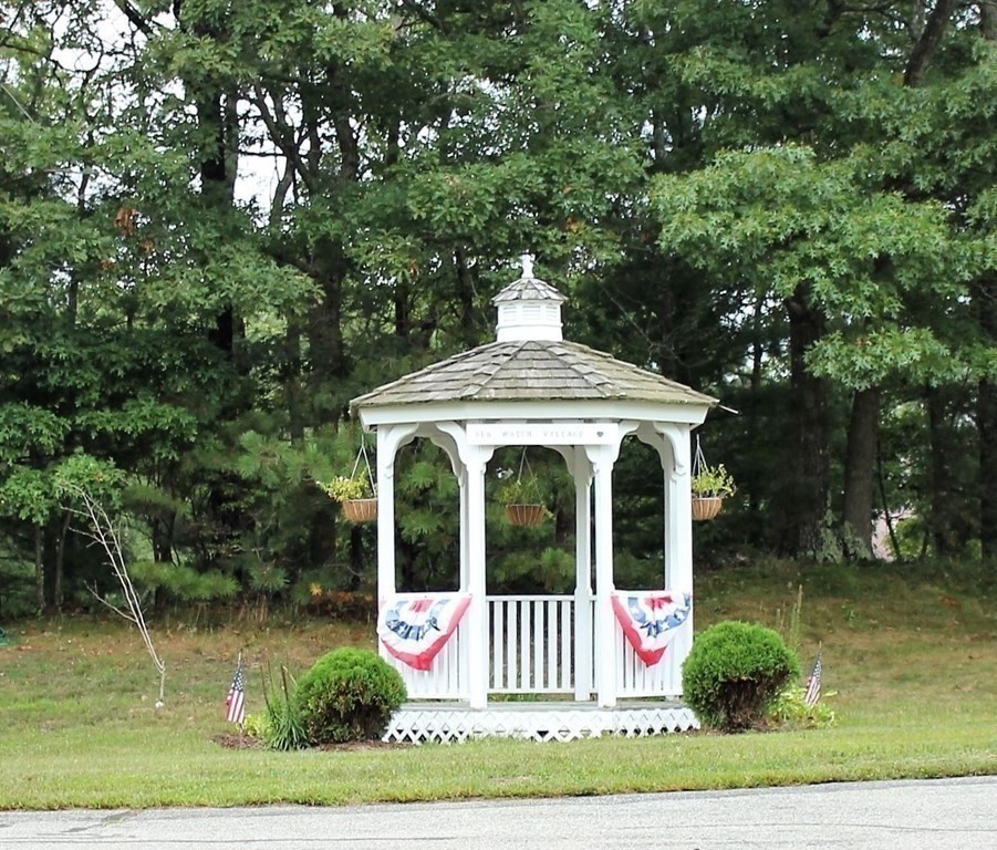 30 Round House Road, Unit 30 Bourne, MA 02532 - Photo 19 of 19 a view of a white house with a yard and large trees