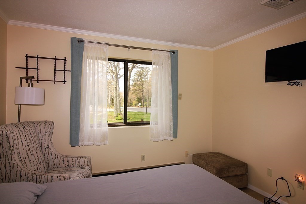 30 Round House Road, Unit 30 Bourne, MA 02532 - Photo 8 of 19 a bedroom with a bed and flat screen tv