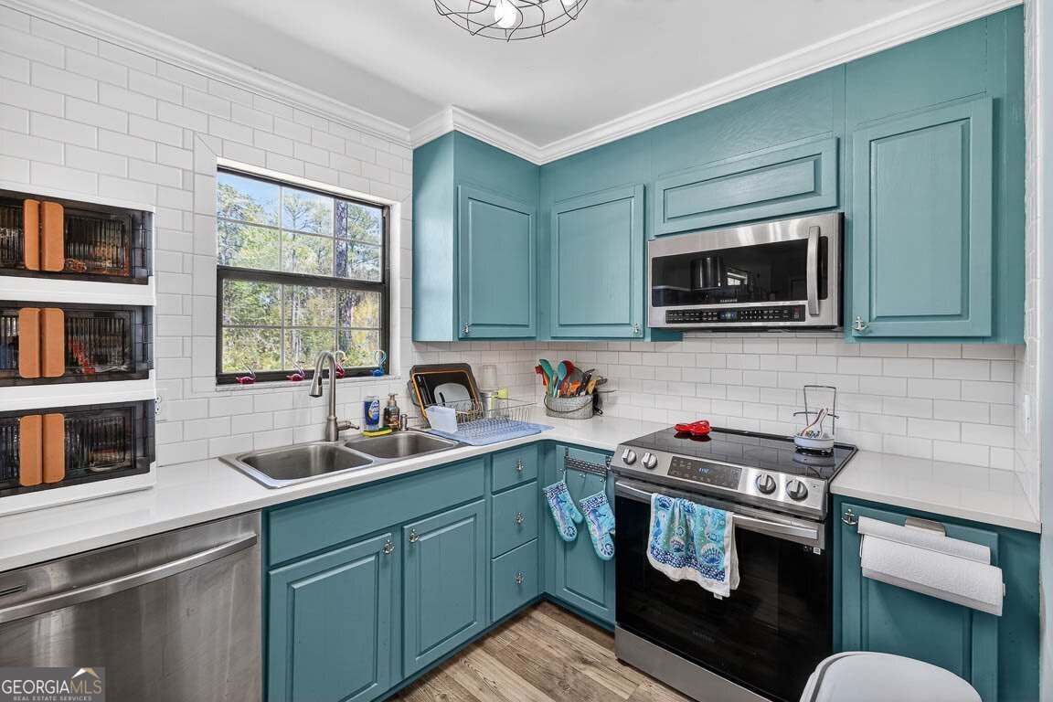 33 Warren Avenue Waverly, GA 31565 - Photo 6 of 63 a kitchen with stainless steel appliances granite countertop a sink stove and microwave