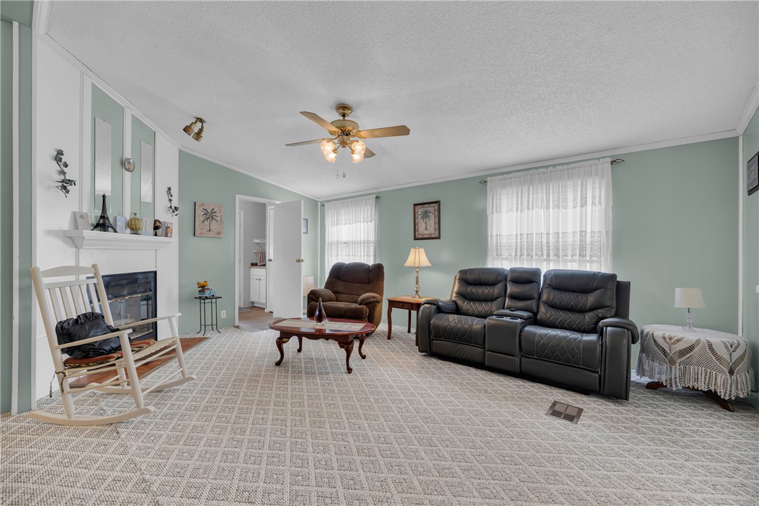 721 Cedar Crest Trail Walhalla, SC 29691 - Photo 20 of 47 A comforting living space features a cozy fireplace and inviting patterned carpet.
