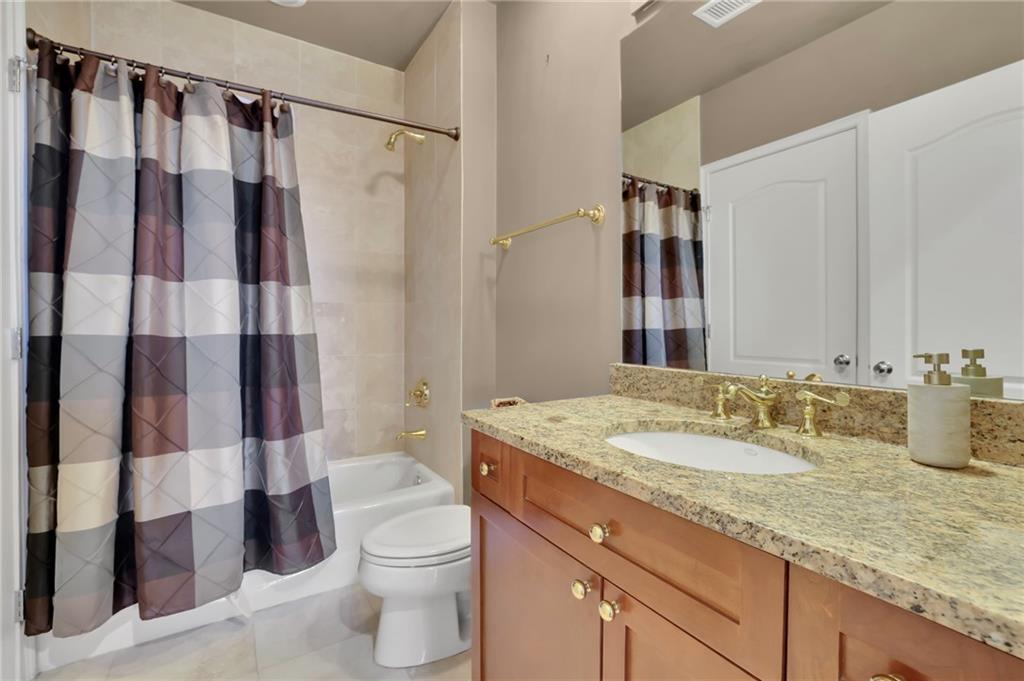 2828 Peachtree Road Northwest, Unit 1901 Atlanta, GA 30305 - Photo 25 of 35 a bathroom with a granite countertop sink toilet and shower