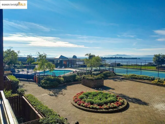 a view of a lake with sunset in background
