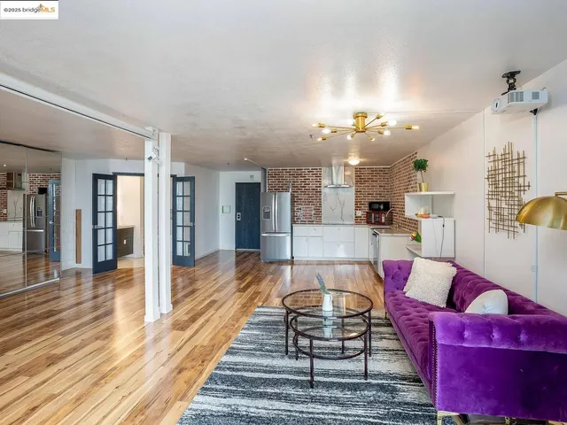a view of hallway with wooden floor and furniture