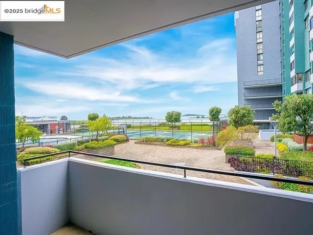 a view of a roof deck with couches and sky view