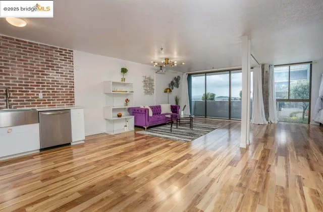 a view of a room with wooden floor and windows