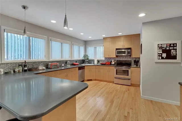 a large kitchen with lots of counter space and stainless steel appliances