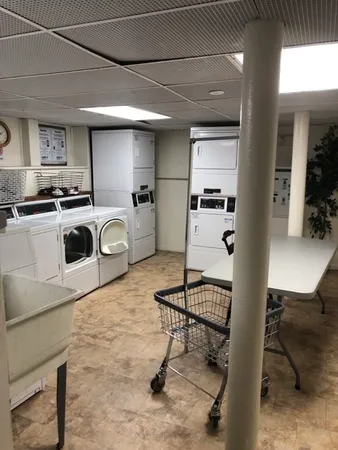 a room with furniture a rug and white walls