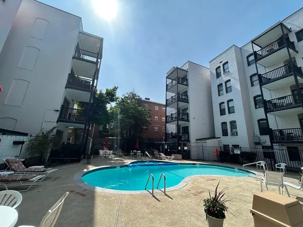 a swimming pool with outdoor seating and yard