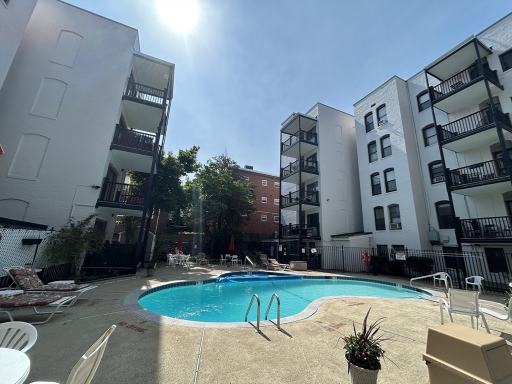 4 Commonwealth Court, Unit 17 Boston, MA 02135 - Photo 13 of 15 a swimming pool with outdoor seating and yard