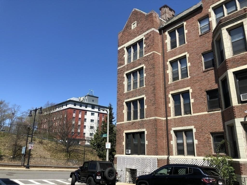 4 Commonwealth Court, Unit 17 Boston, MA 02135 - Photo 15 of 15 a view of a building next to a yard