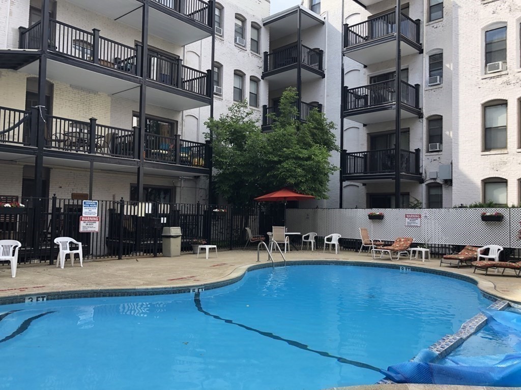 4 Commonwealth Court, Unit 17 Boston, MA 02135 - Photo 2 of 15 a swimming pool with outdoor seating and yard