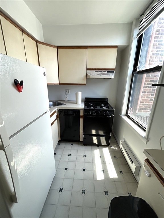 4 Commonwealth Court, Unit 17 Boston, MA 02135 - Photo 3 of 15 a kitchen with a refrigerator and a more cabinets