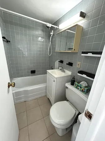 a bathroom with a toilet sink and shower