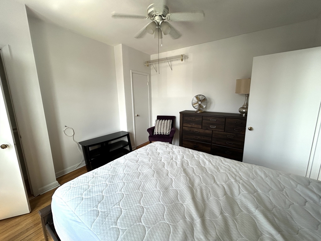 4 Commonwealth Court, Unit 17 Boston, MA 02135 - Photo 10 of 15 a bedroom with a bed and a dresser