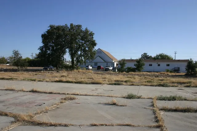 a view of a street with a building in the background