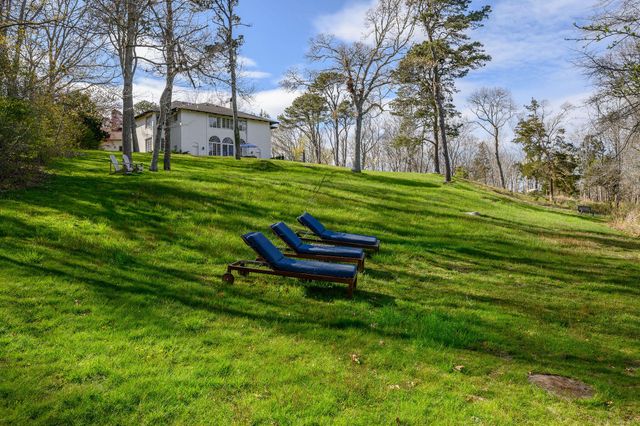 a living room with fireplace furniture and a wooden floor
