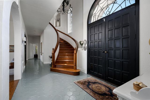 a living room with furniture chandelier and a large window