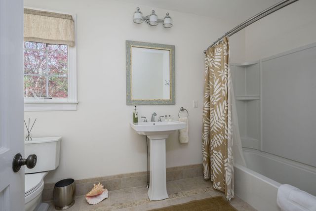 a backyard of a house with lots of green space and fountain