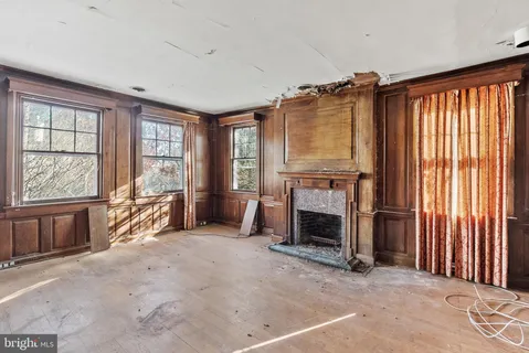 an empty room with furniture and a fireplace